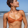 Terracotta orange ribbed underwire bikini top with sustainable Amni Soul Eco fabric and luxe gold clasps, embodying eco-luxury swimwear trends.