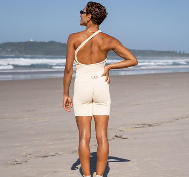 Stylish vanilla cream biker shorts with ribbed texture, offering full coverage for yoga and high-intensity workouts, blending fashion with eco-conscious design.