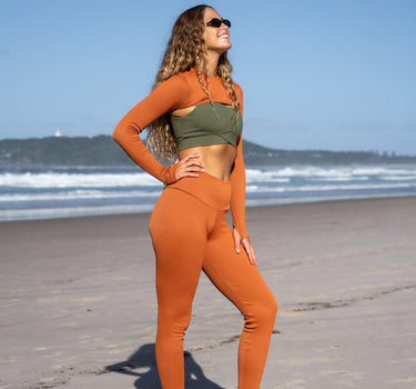 Eco-chic terracotta ribbed leggings by F.lux, offering both style and sustainability with advanced biodegradable materials, ideal for yoga and high-intensity workouts.