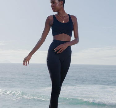 Ethically crafted Black Bruna Sports Bra, featuring snug elastic front and crossover fabric, a testament to ethical fashion in Australia's activewear scene.