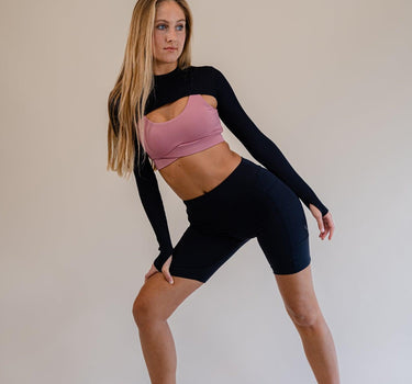 Ethically crafted Barbie pink sports bra with sleek V-back, supporting environmental wellness and ethical labor practices.